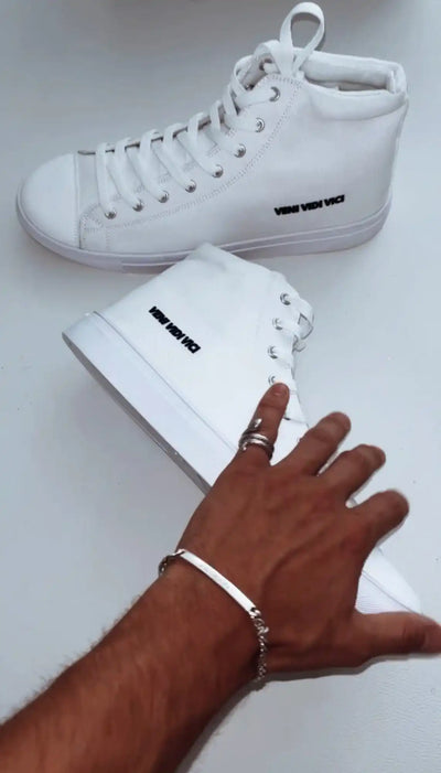 Pair of white high-top sneakers.